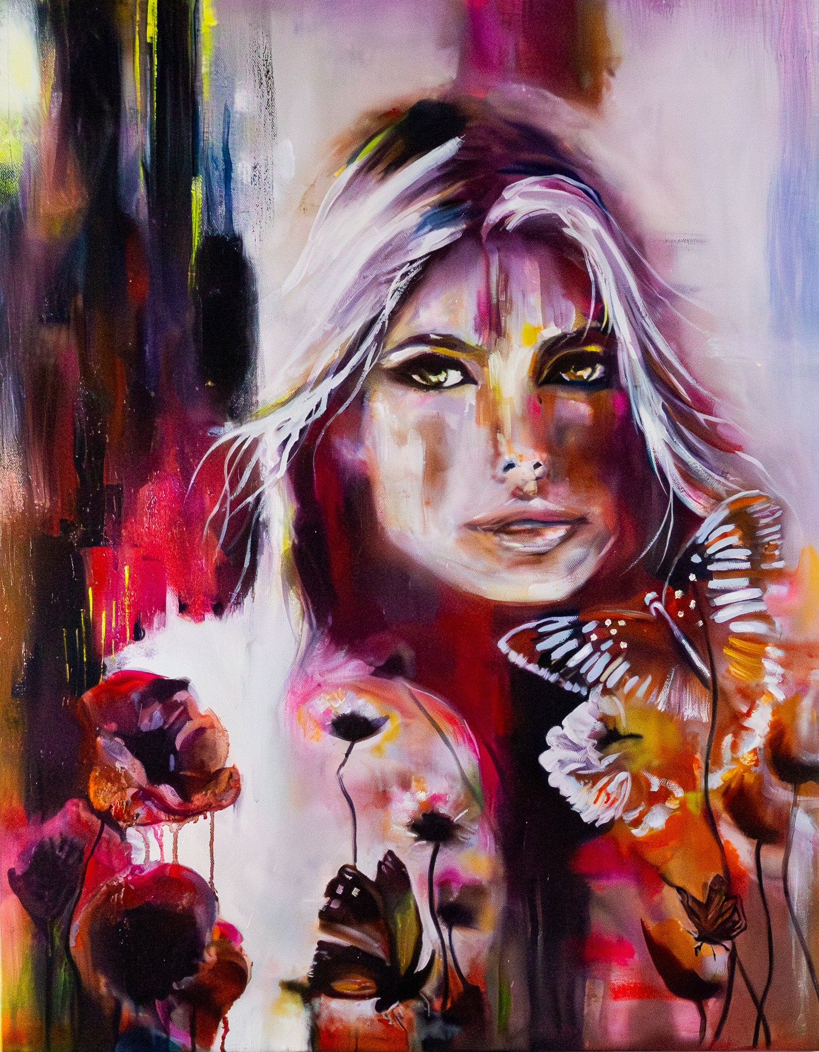 Oil painting titled “Where Butterflies Rest” is a vibrant view of a woman’s face with flowing white hard, surrounded by colorful butterflies and flowers in warm reds, oranges and purples with dramatic brushstrokes.